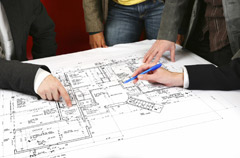 People collaborating over architectural plans